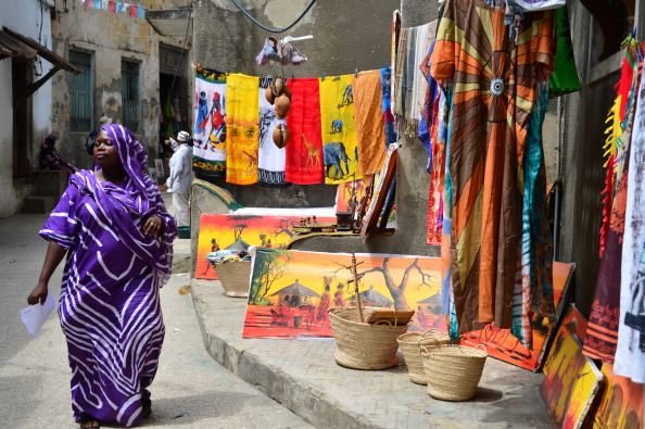 A local woman walks by a shop in Stone Town in Zanzibar on January 2013. Photo credit: GABRIEL BOUYS/AFP/Getty Images
